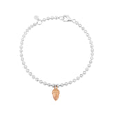 A sterling silver bracelet with rose gold beaded details and an acorn charm, adjustable in length.